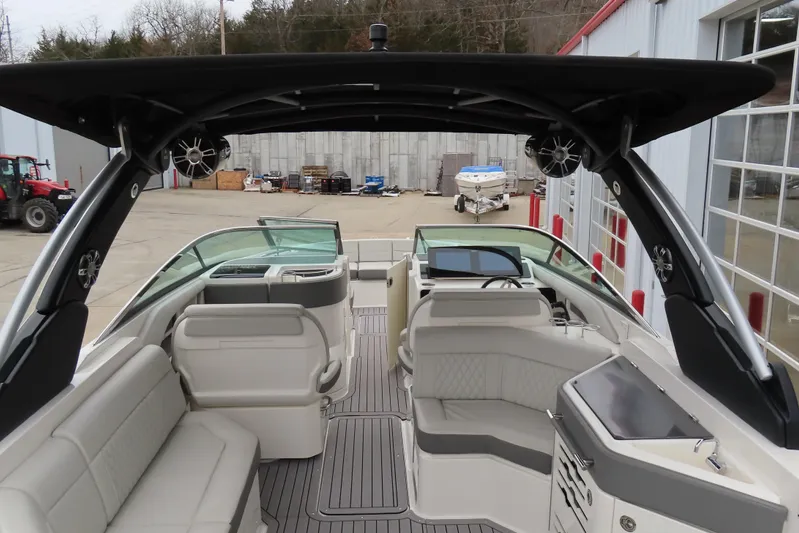  Yacht Photos Pics 2021 Sea Ray 310 SLX boat interior with seating and helm, docked outdoors.