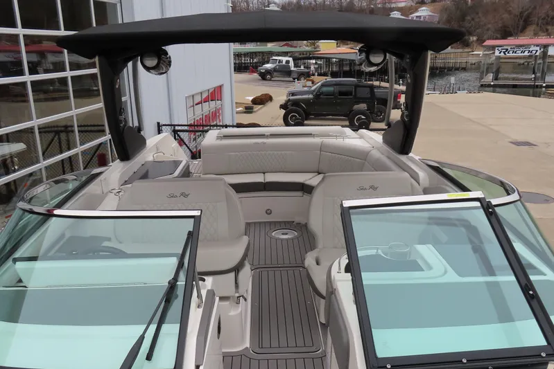  Yacht Photos Pics 2021 Sea Ray 310 SLX boat with spacious seating and sleek design at a marina.