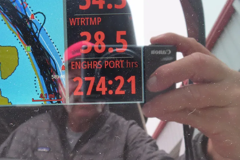  Yacht Photos Pics Reflection of a person photographing a Sea Ray 310 SLX boat's digital display.
