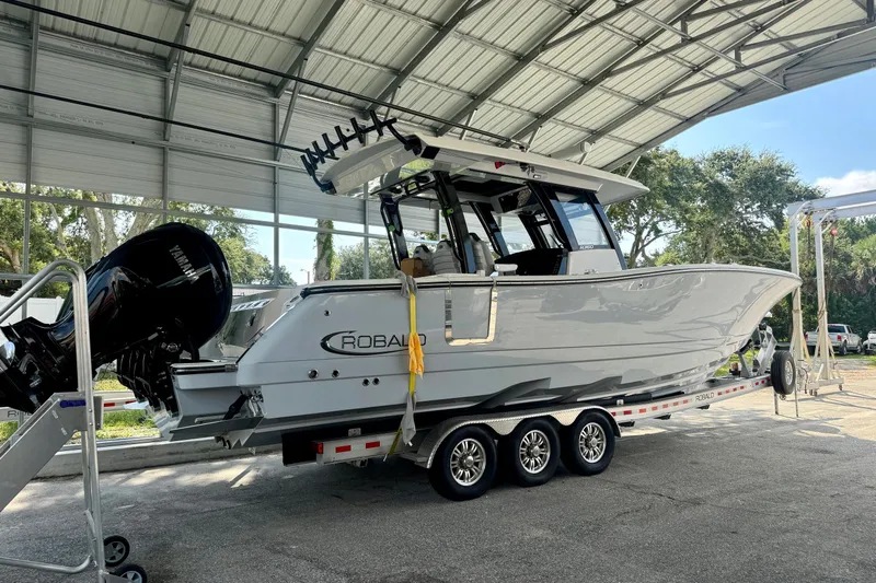 No Joke Yacht Photos Pics 2022 Robalo R360 Center Console boat on trailer under shelter.