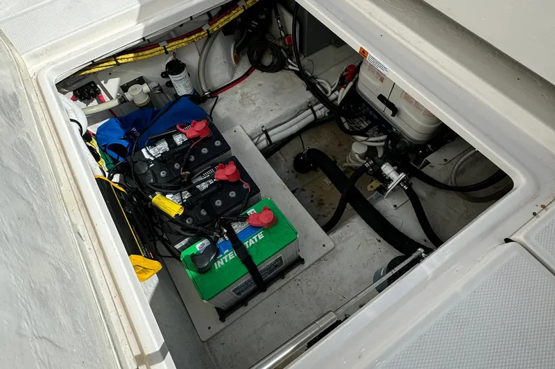 No Joke Yacht Photos Pics 2022 Robalo R360 Center Console boat battery compartment with wiring and equipment.