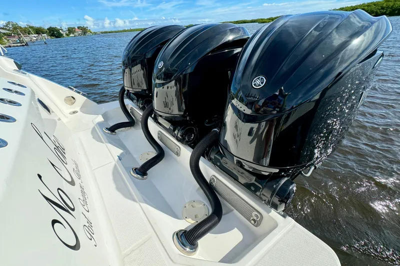 No Joke Yacht Photos Pics 2022 Robalo R360 Center Console with triple outboard engines on water.