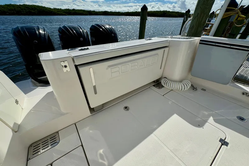 No Joke Yacht Photos Pics 2022 Robalo R360 Center Console boat with triple outboard engines docked by the water.