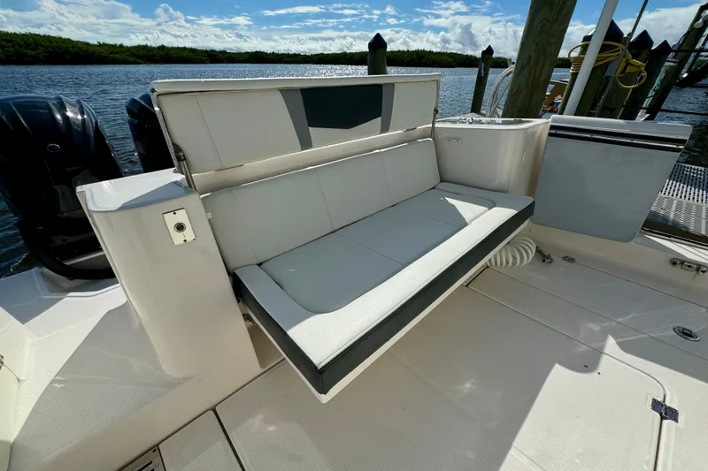 No Joke Yacht Photos Pics 2022 Robalo R360 Center Console boat with foldable seating and scenic water backdrop.