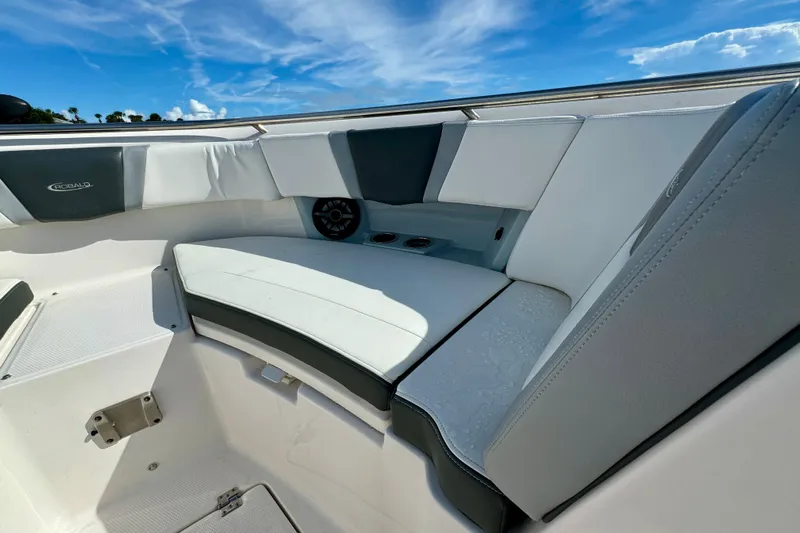 No Joke Yacht Photos Pics 2022 Robalo R360 Center Console boat interior with cushioned seating and speaker.