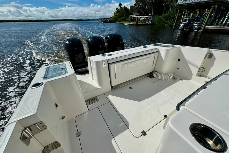 No Joke Yacht Photos Pics 2022 Robalo R360 Center Console boat cruising on a scenic waterway.