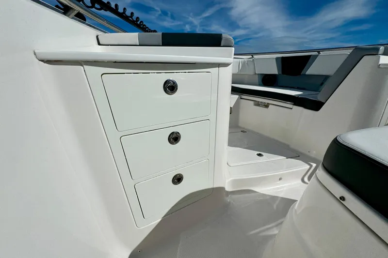 No Joke Yacht Photos Pics 2022 Robalo R360 Center Console interior with storage drawers and seating.
