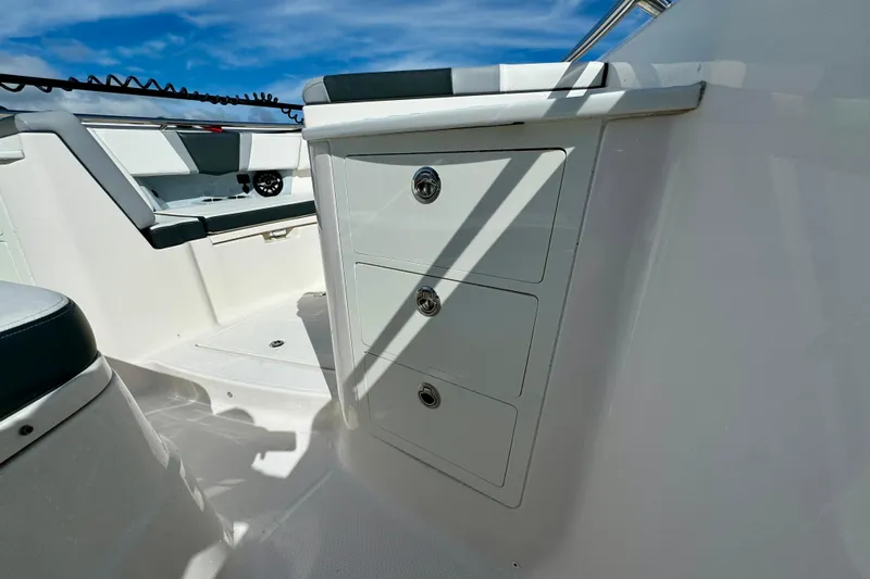 No Joke Yacht Photos Pics 2022 Robalo R360 Center Console interior with storage drawers and seating.