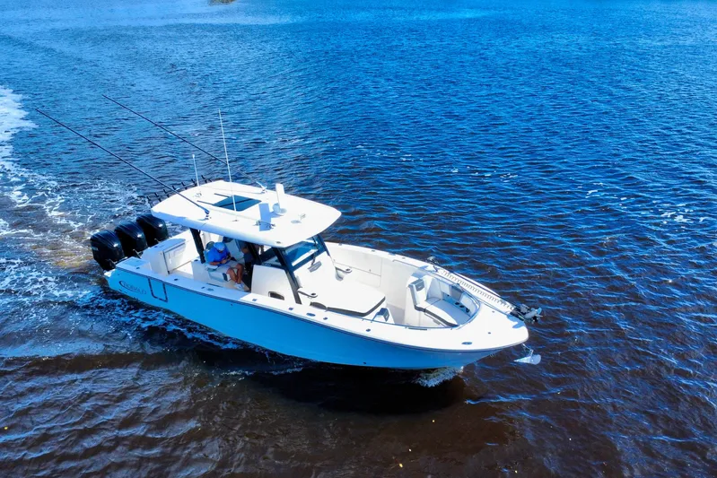 No Joke Yacht Photos Pics 2022 Robalo R360 Center Console boat cruising on open water.