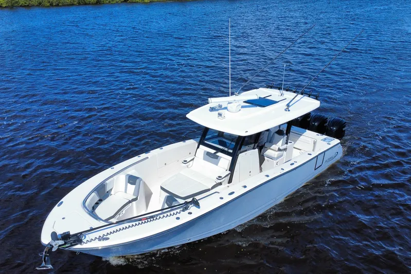 No Joke Yacht Photos Pics 2022 Robalo R360 Center Console boat cruising on blue water.