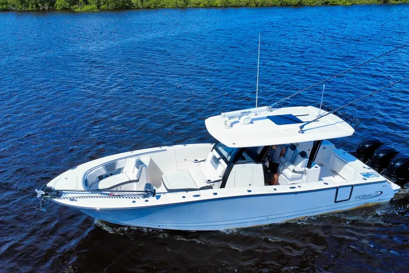 No Joke Yacht Photos Pics 2022 Robalo R360 Center Console boat cruising on blue water.