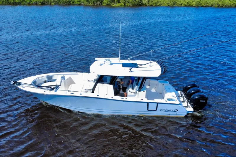 No Joke Yacht Photos Pics 2022 Robalo R360 Center Console boat cruising on blue water.