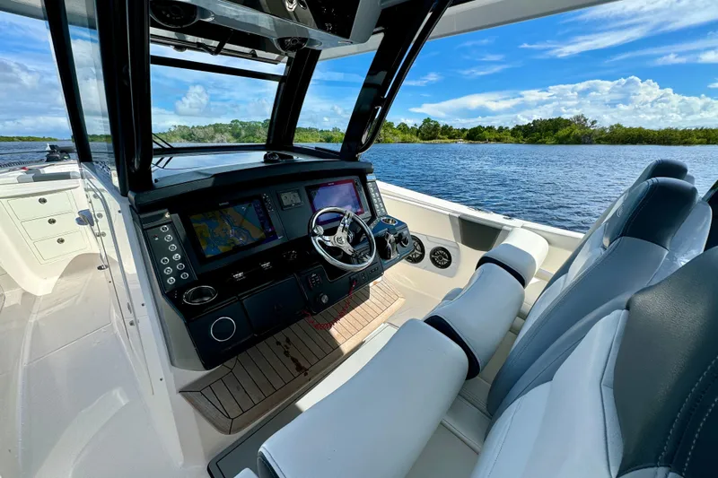No Joke Yacht Photos Pics 2022 Robalo R360 Center Console boat interior with advanced navigation system on a sunny day.