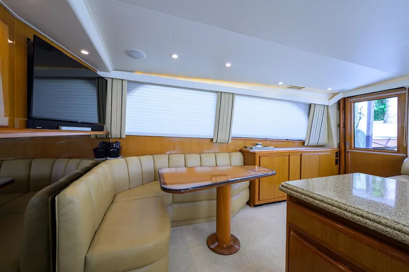 Alli-gator Yacht Photos Pics Luxurious interior of a 2000 Viking 50 Convertible yacht with elegant seating and wooden finishes.