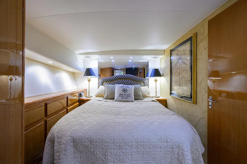 Alli-gator Yacht Photos Pics Luxurious bedroom interior of 2000 Viking 50 Convertible yacht with elegant bedding and ambient lighting.