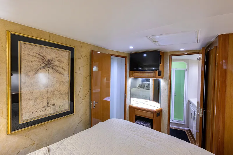 Alli-gator Yacht Photos Pics Interior of 2000 Viking 50 Convertible yacht with bedroom, TV, and bathroom.