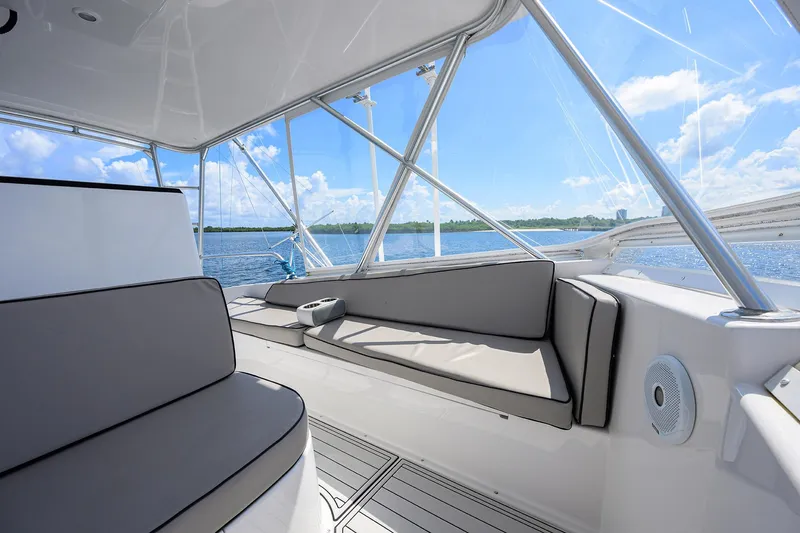 Alli-gator Yacht Photos Pics Interior view of 2000 Viking 50 Convertible yacht with cushioned seating and ocean backdrop.