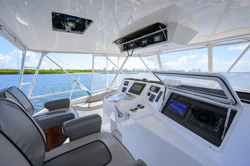 Alli-gator Yacht Photos Pics Helm of 2000 Viking 50 Convertible yacht with modern navigation equipment and ocean view.