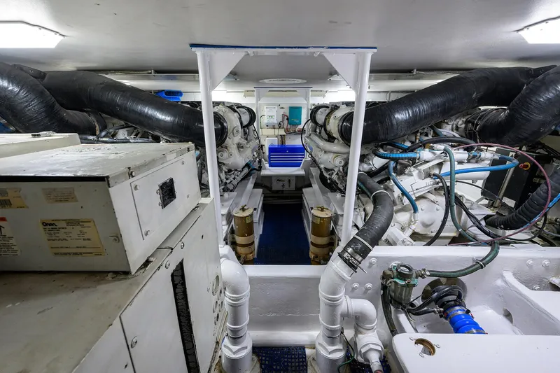 Alli-gator Yacht Photos Pics Engine room of 2000 Viking 50 Convertible yacht, showcasing machinery and piping systems.