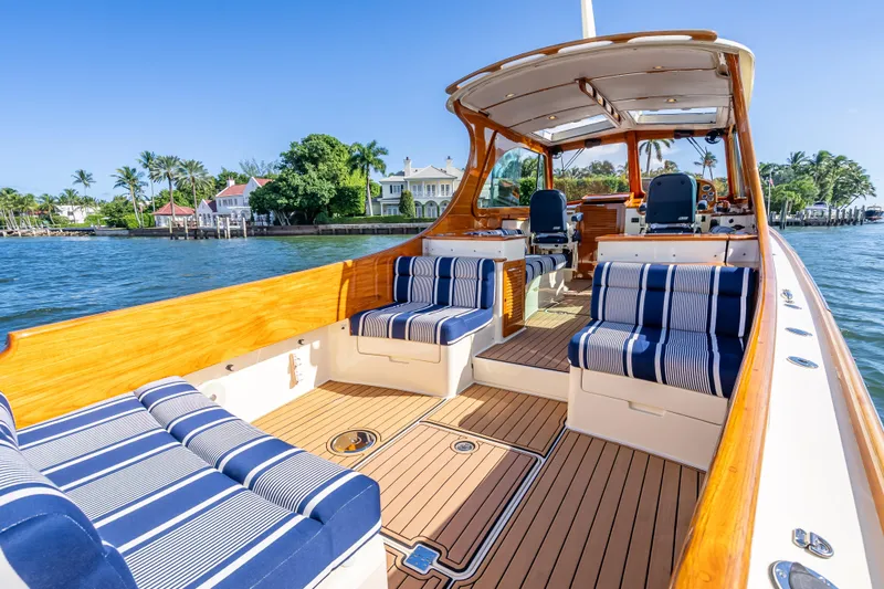 Gracious Yacht Photos Pics 2018 Hinckley Picnic Boat 37 MKIII with elegant seating, docked by waterfront homes.