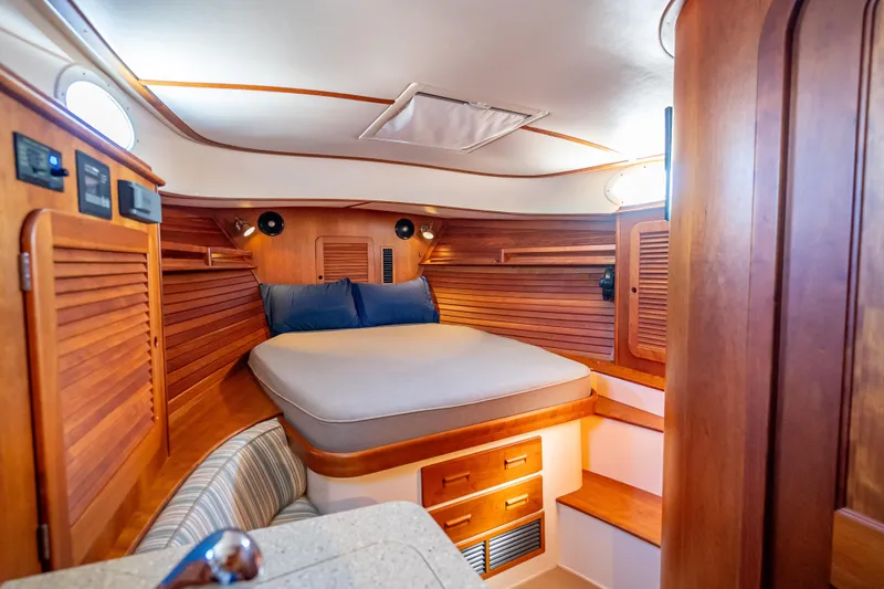 Gracious Yacht Photos Pics Luxurious cabin interior of 2018 Hinckley Picnic Boat 37 MKIII with wooden finish.