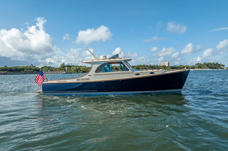 Gracious Yacht Photos Pics 2018 Hinckley Picnic Boat 37 MKIII cruising on a sunny day with an American flag.