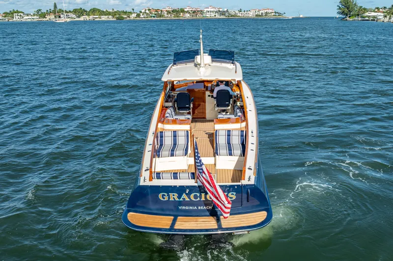 Gracious Yacht Photos Pics 2018 Hinckley Picnic Boat 37 MKIII cruising on open water, rear view.