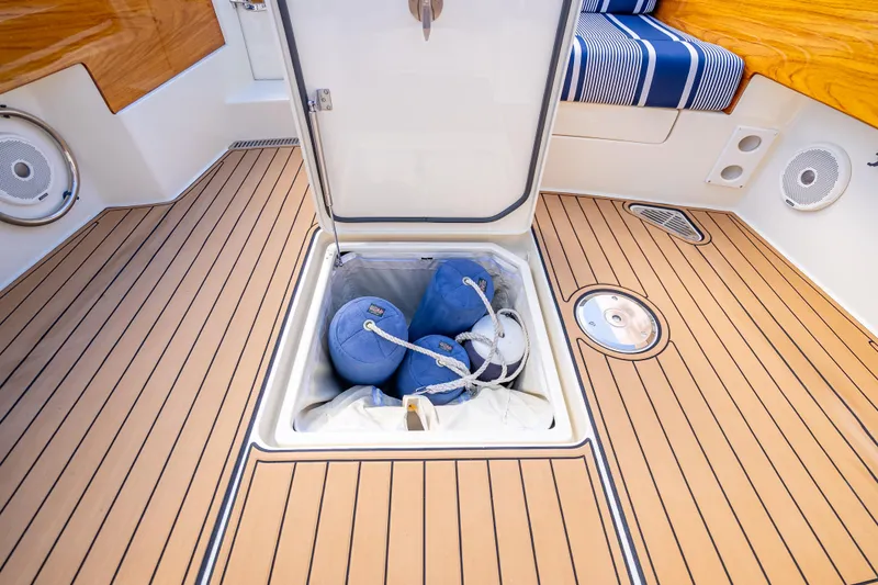 Gracious Yacht Photos Pics Hinckley Picnic Boat 37 MKIII 2018 deck with open storage compartment and blue fenders.