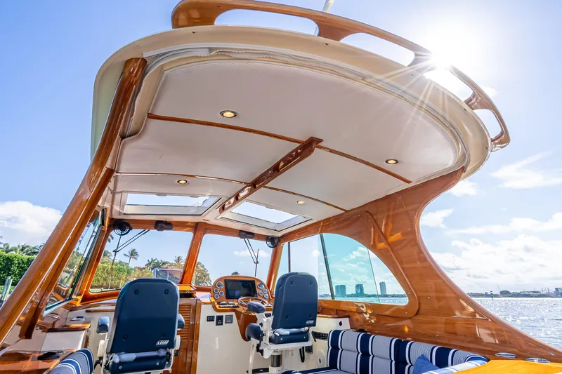 Gracious Yacht Photos Pics 2018 Hinckley Picnic Boat 37 MKIII interior with elegant wood finish and modern controls.