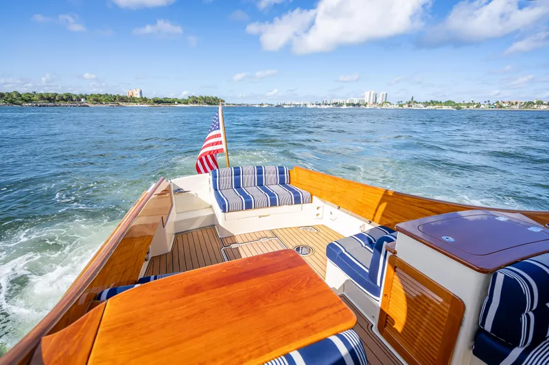 Gracious Yacht Photos Pics 2018 Hinckley Picnic Boat 37 MKIII cruising with striped seating and American flag.