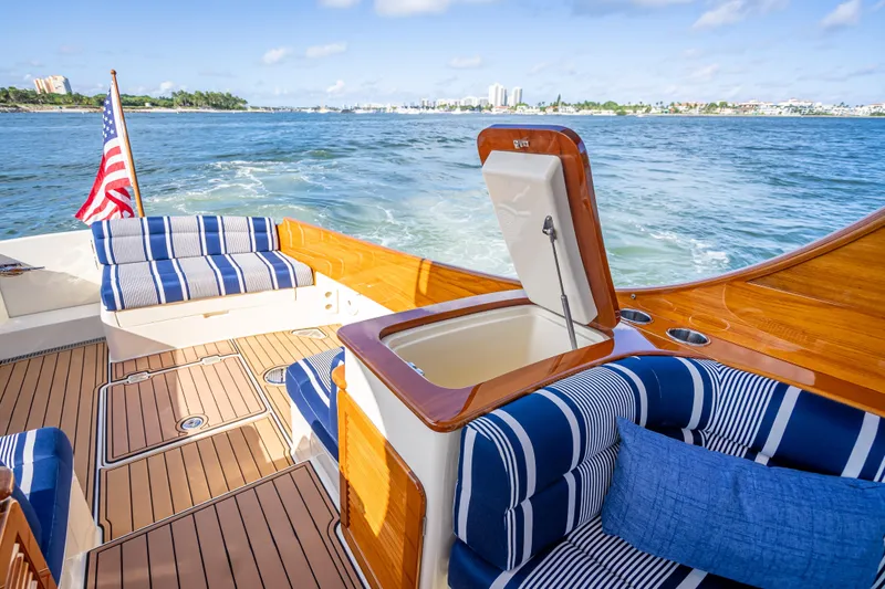 Gracious Yacht Photos Pics 2018 Hinckley Picnic Boat 37 MKIII with striped seating, open water view, and American flag.