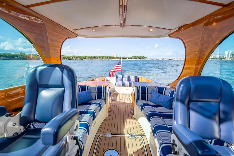Gracious Yacht Photos Pics Luxurious 2018 Hinckley Picnic Boat 37 MKIII interior with striped seating and scenic water view.