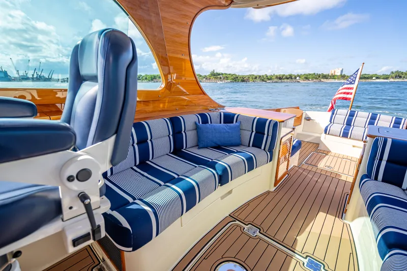 Gracious Yacht Photos Pics Luxurious 2018 Hinckley Picnic Boat 37 MKIII interior with striped seating and scenic ocean view.