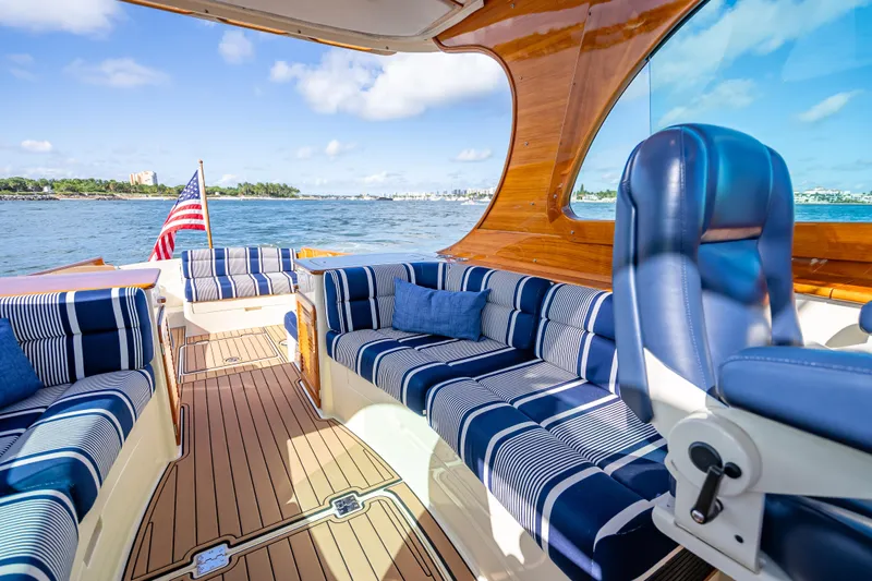 Gracious Yacht Photos Pics Luxurious 2018 Hinckley Picnic Boat 37 MKIII interior with striped seating and scenic ocean view.