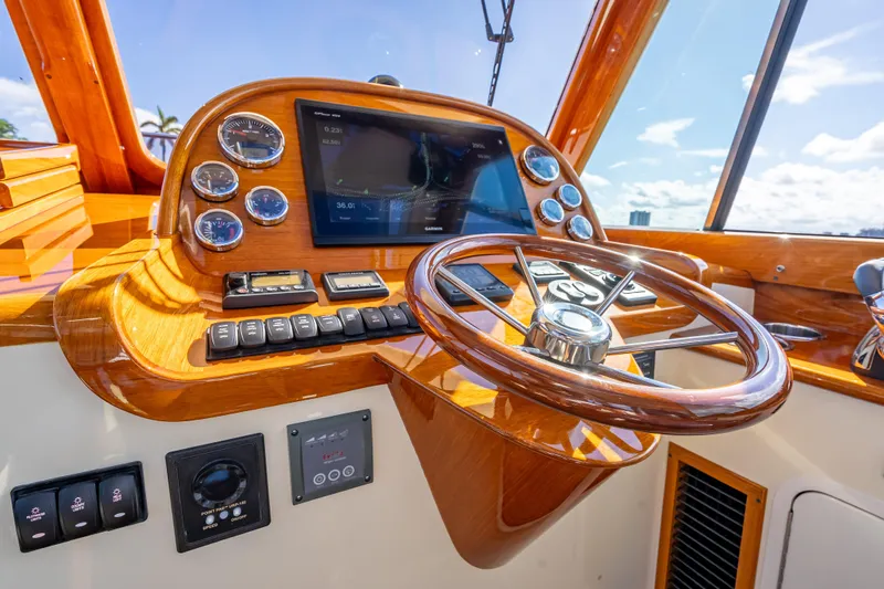 Gracious Yacht Photos Pics Helm of 2018 Hinckley Picnic Boat 37 MKIII with wooden steering wheel and modern controls.
