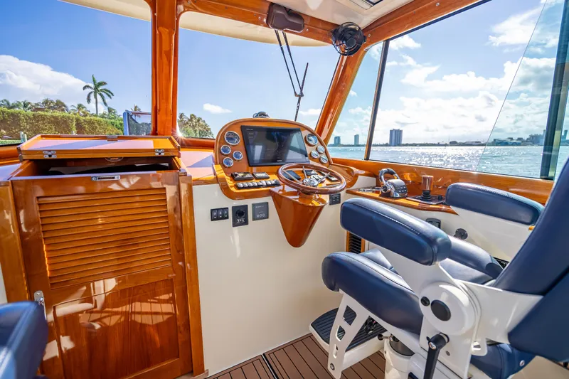 Gracious Yacht Photos Pics Helm of 2018 Hinckley Picnic Boat 37 MKIII with luxurious wood finish and ocean view.