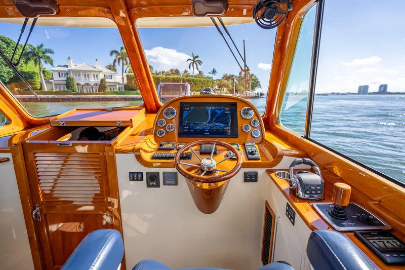 Gracious Yacht Photos Pics 2018 Hinckley Picnic Boat 37 MKIII helm with luxurious wood finish and modern navigation system.