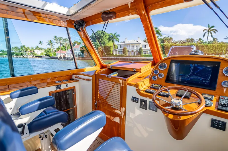Gracious Yacht Photos Pics Interior of 2018 Hinckley Picnic Boat 37 MKIII with luxurious helm and waterfront view.