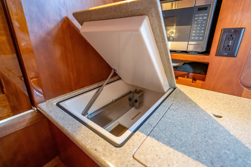 Gracious Yacht Photos Pics Hinckley Picnic Boat 37 MKIII 2018 galley with open storage compartment and microwave.