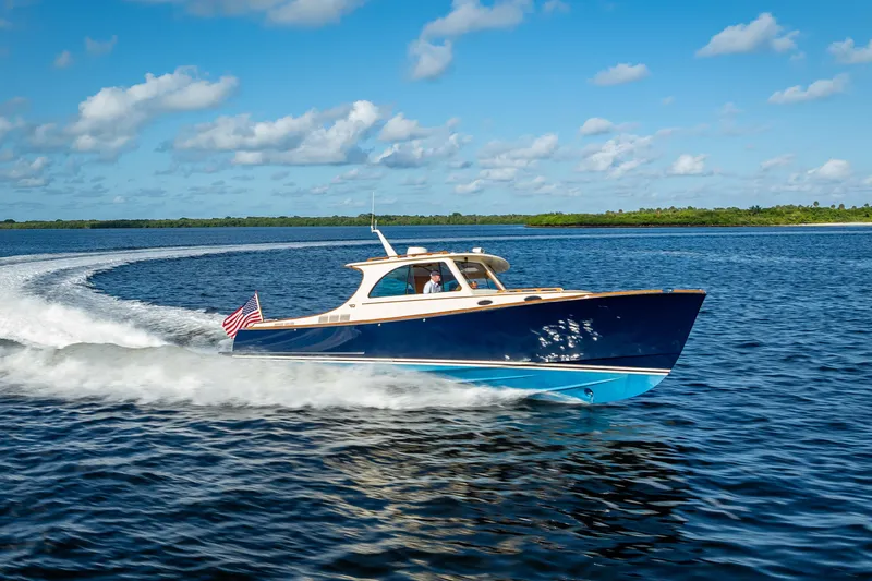Gracious Yacht Photos Pics 2018 Hinckley Picnic Boat 37 MKIII cruising on open water under blue skies.