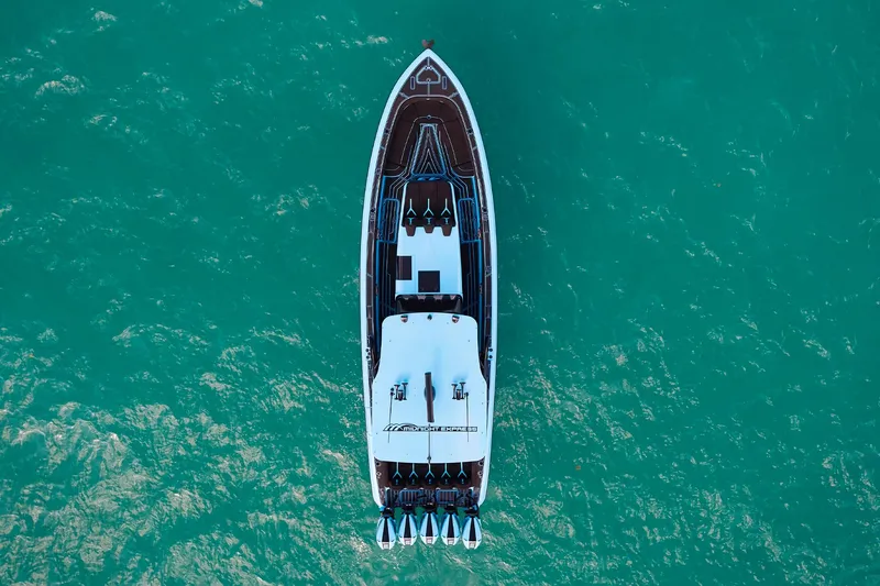  Yacht Photos Pics Aerial view of 2024 Midnight Express 43' Solstice yacht on turquoise water.