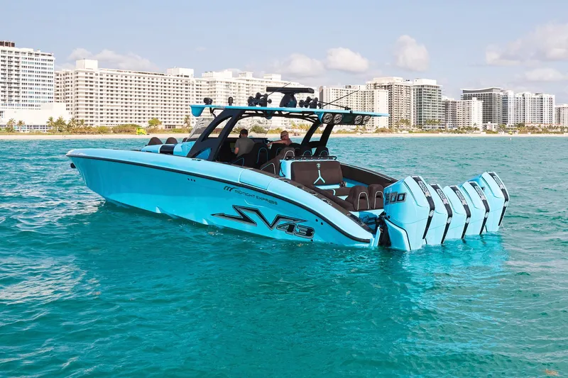  Yacht Photos Pics 2024 Midnight Express 43' Solstice boat on turquoise water, city skyline in background.