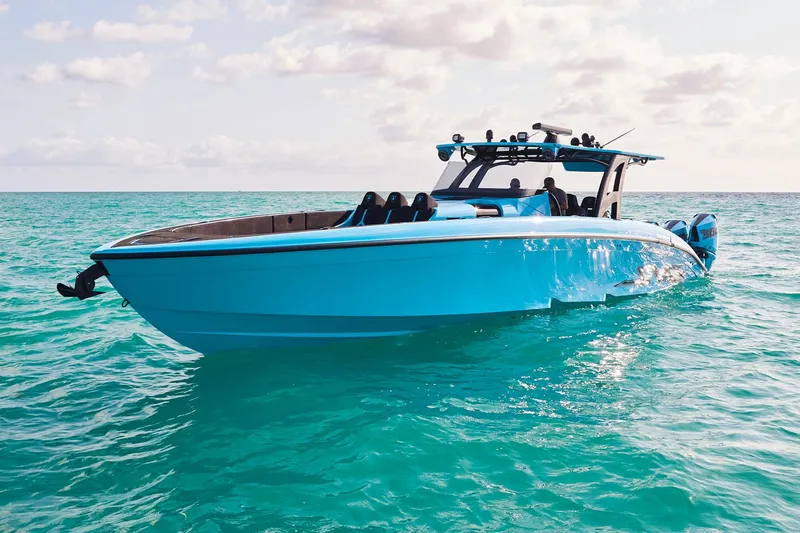  Yacht Photos Pics 2024 Midnight Express 43' Solstice boat on turquoise water under a partly cloudy sky.