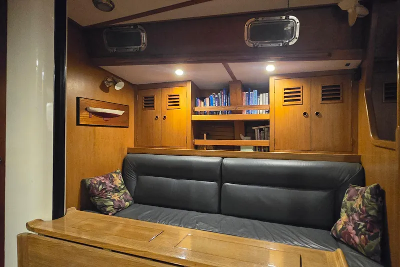Simplicity Yacht Photos Pics Interior of 1986 Cambria 46 yacht with cozy seating and wooden cabinetry.