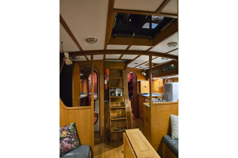 Simplicity Yacht Photos Pics Interior of 1986 Cambria 46 yacht, featuring wooden furnishings and cozy seating area.