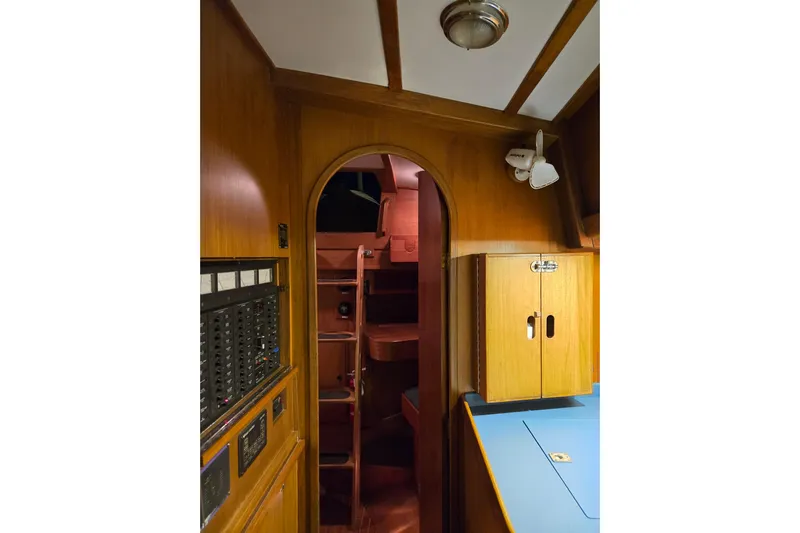 Simplicity Yacht Photos Pics Interior of 1986 Cambria 46 sailboat with wooden cabinetry and control panel.