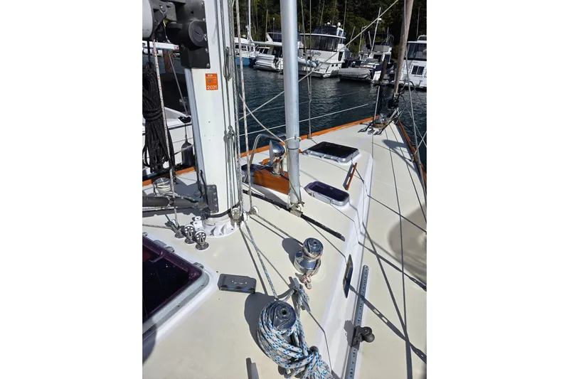 Simplicity Yacht Photos Pics Sailboat deck view of 1986 Cambria 46, featuring rigging and winches in a marina.