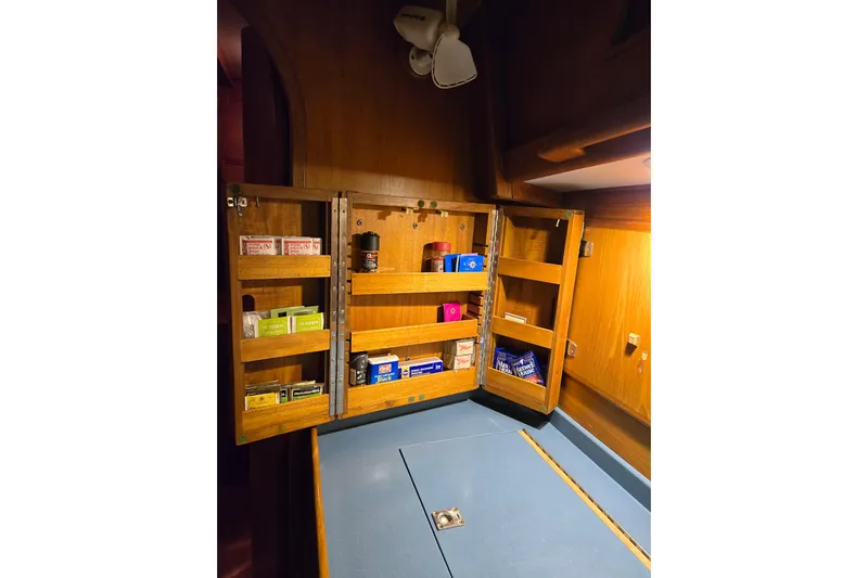 Simplicity Yacht Photos Pics Wooden cabinet with open shelves in a 1986 Cambria 46 yacht interior.