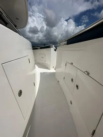 Unicorn Yacht Photos Pics 2020 Hampton 658l Endurance yacht deck with storage compartments under cloudy sky.