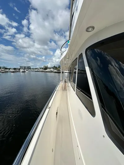 Unicorn Yacht Photos Pics Side view of 2020 Hampton 658l Endurance yacht on calm water under blue sky.